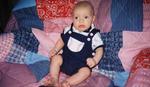 Sitting on the quilt and looking cute