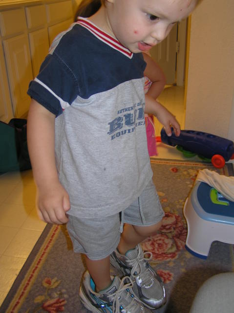 Jacob tries his mom's shoes on for size