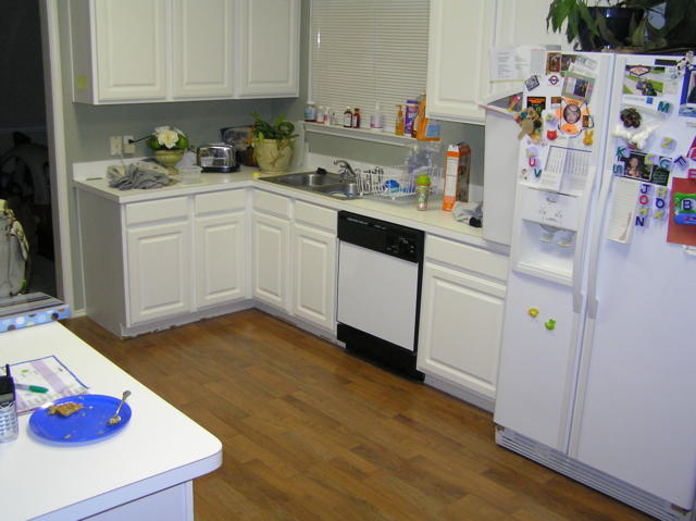 The kitchen with its new laminate wood floor