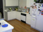 The kitchen with its new laminate wood floor