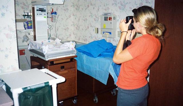 Auntie Em takes pictures of the hospital room