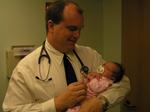 Doctor Joel Walker, Lacy and Jacob's pediatrician, gives her a good bill of health