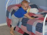 Jacob shows how he can climb into and out of his toddler bed
