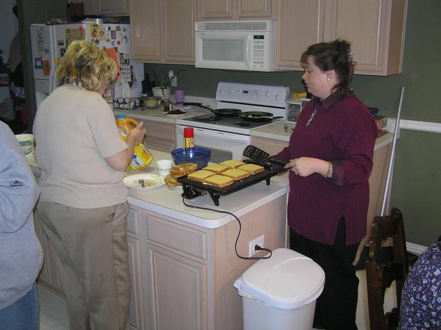 Grandma Morris and Kathy's sister Christie make some French toast to celebrate after the baptism