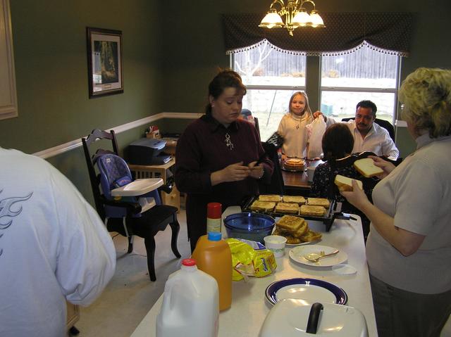 Christie and Grandma create more French toast as Jason's daughter Bailey, Kathy, and Christie's husband Christpin enjoy some barbacoa breakfast tacos.